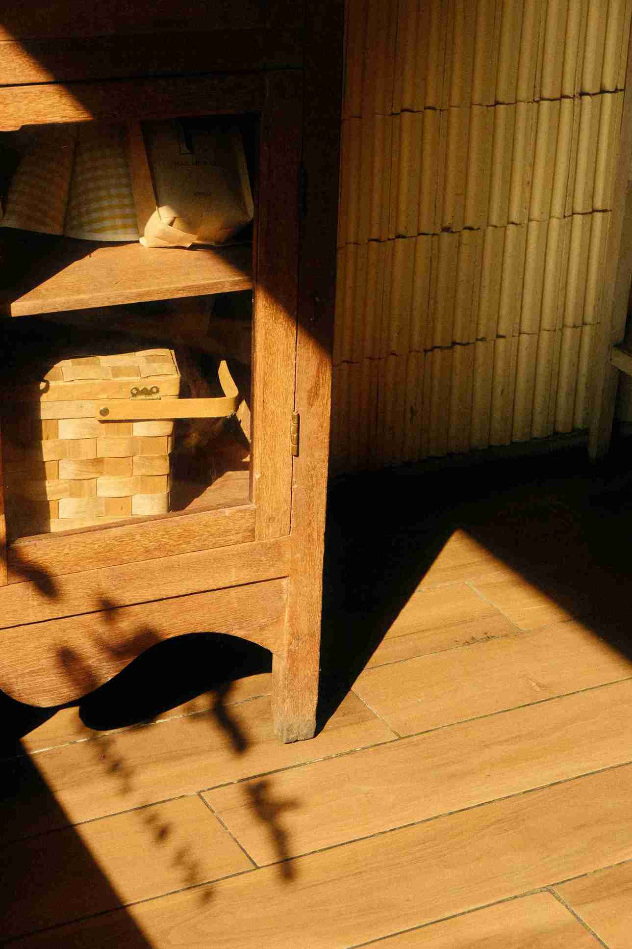 “Luxury wooden cat furniture with minimalist design, featuring a cat lounging on a wooden perch and scratching post.”